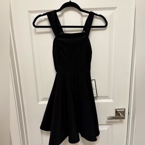 Short A line black party dress with silver crystal detail.